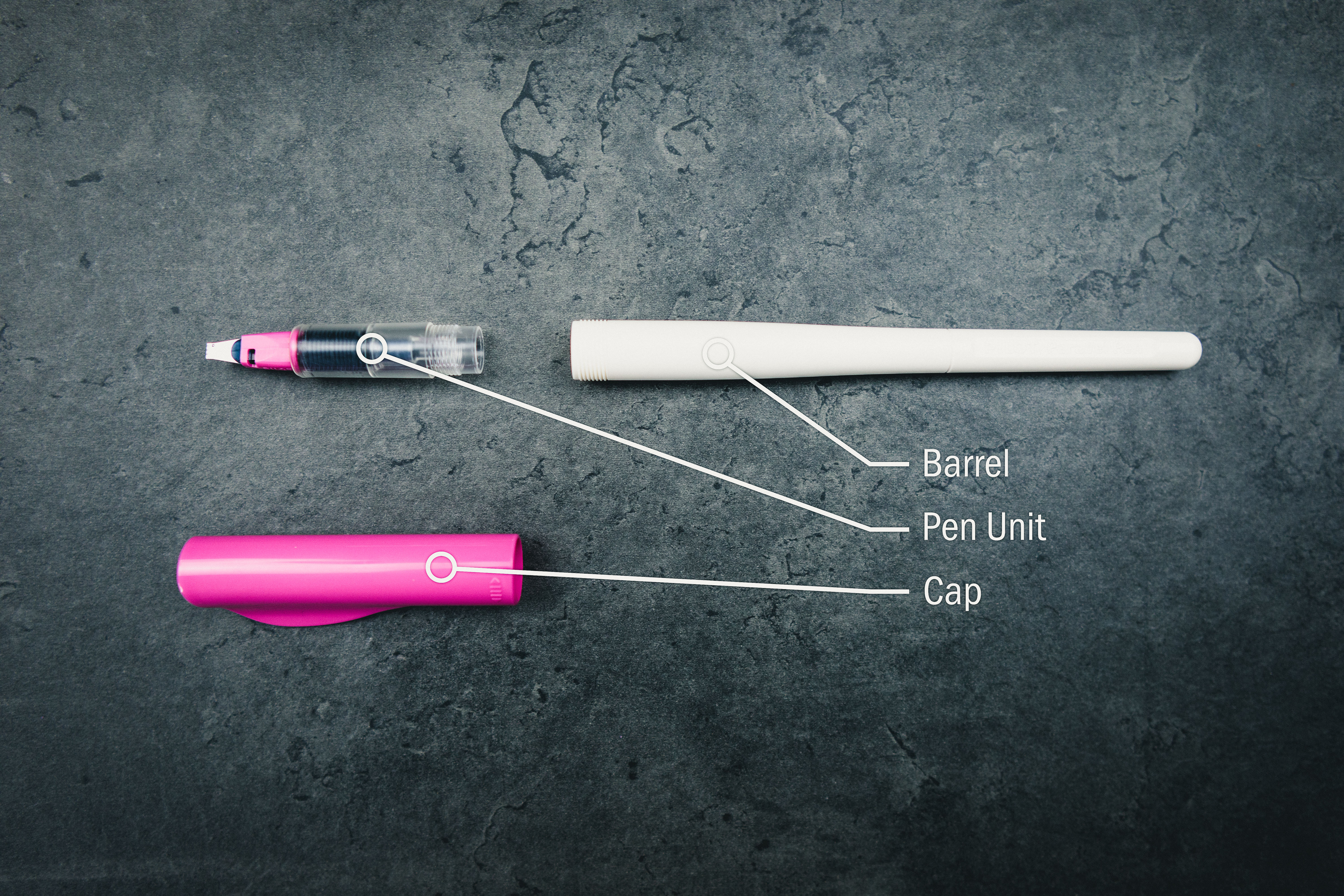 3mm-pink-pilot-parallel-barrel-pen-unit-cap 3mm pink pilot parallel pen with pen unit (feed, nib controller, neck, nib, grip) separated from barrel resting on grey granite surface